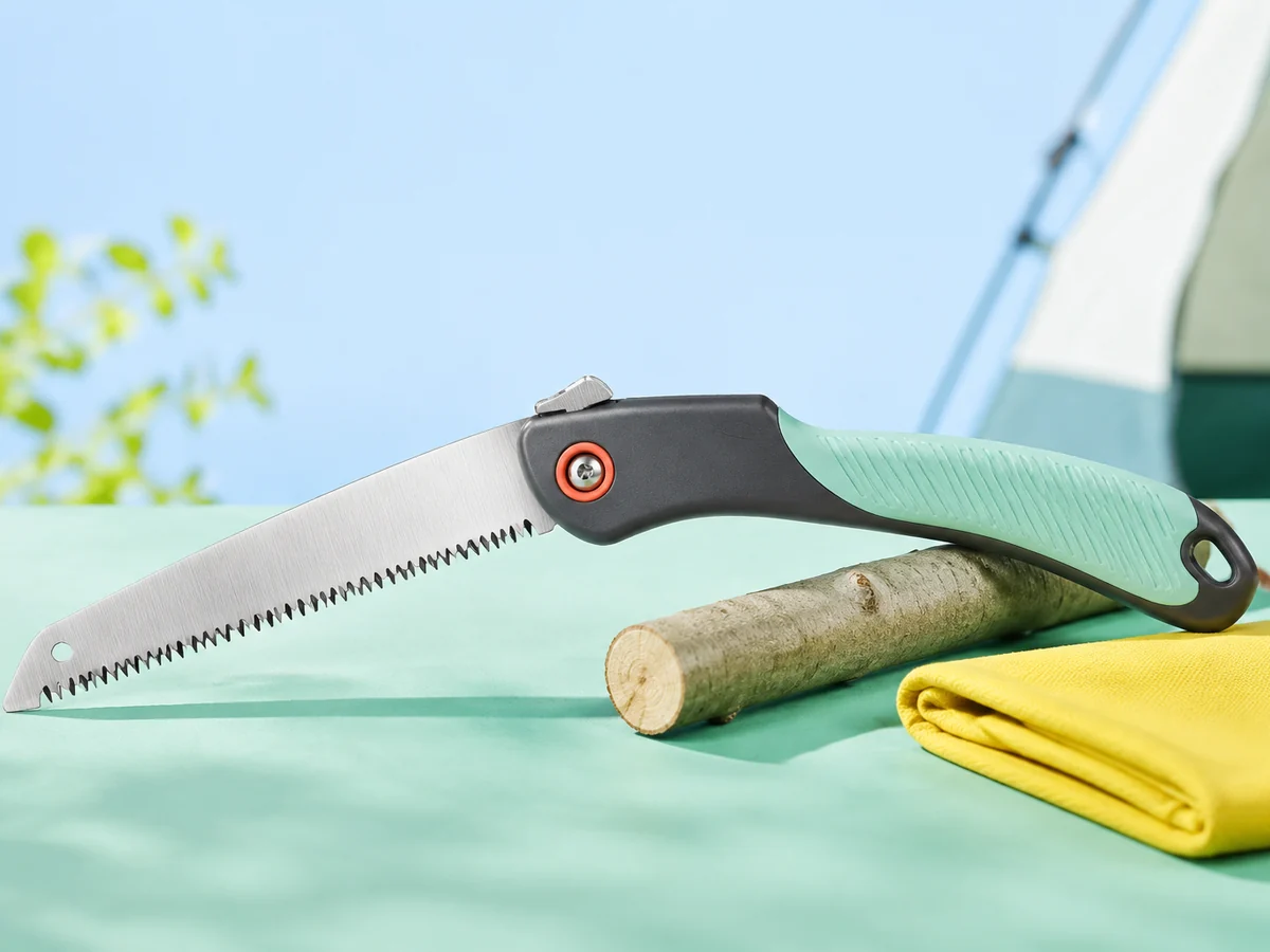 Folding camp hand saw shown open with coarse teeth, a locking pivot, and a mint grip.